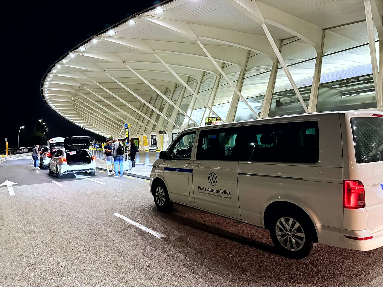 Furgoneta de 8 plazas junto a la terminal del aeropuerto de noche